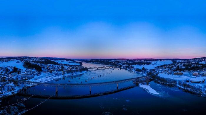 Winter sunset over a river with bridges in Norway