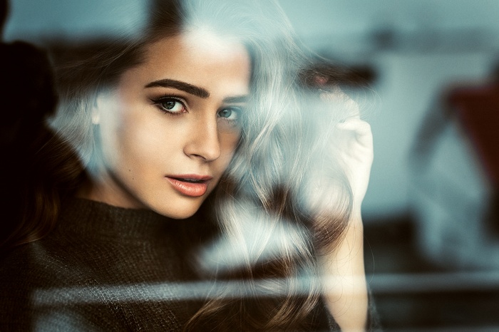 Woman looking through glass
