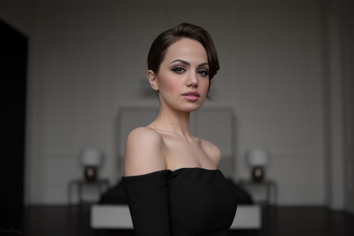 Woman with bare shoulders in black dress by Ivan Proskurin