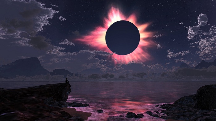 Solar eclipse over ocean with person watching