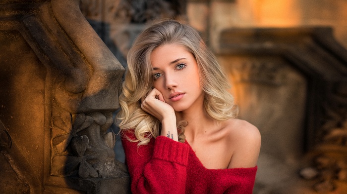 Woman with blonde hair in a red sweater