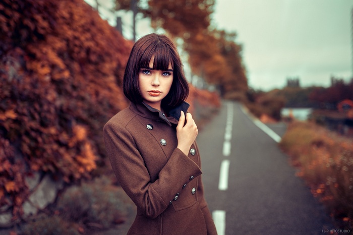 Marie Grippon in a brown coat on a road