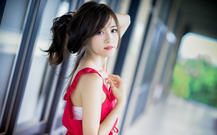 Young Asian woman in red dress