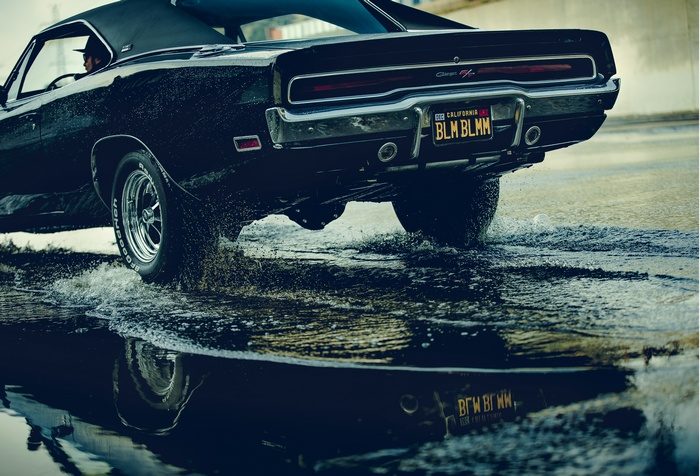Black Dodge Charger driving through water