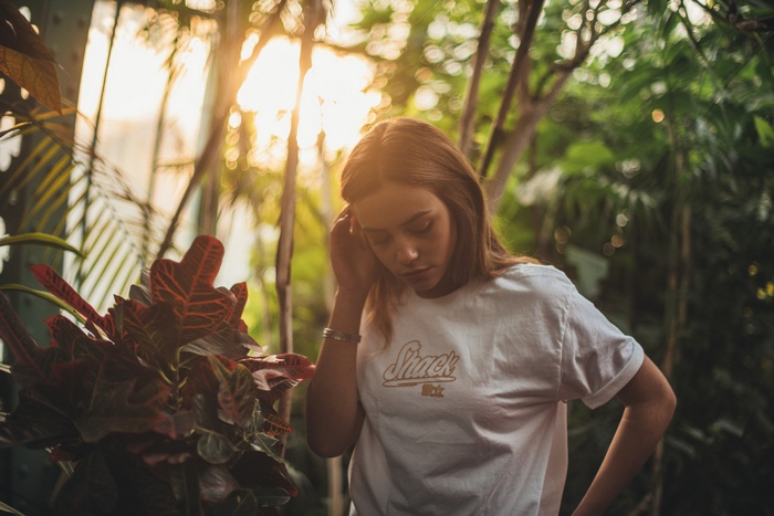 Woman in a greenhouse with sun rays