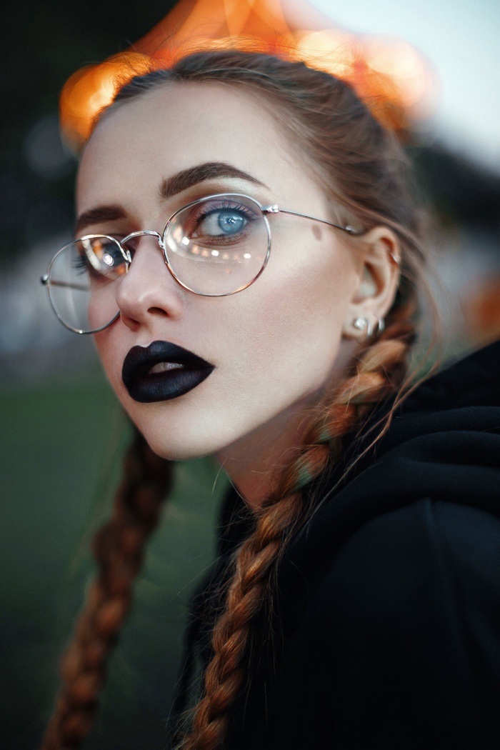 Woman with glasses and black lipstick