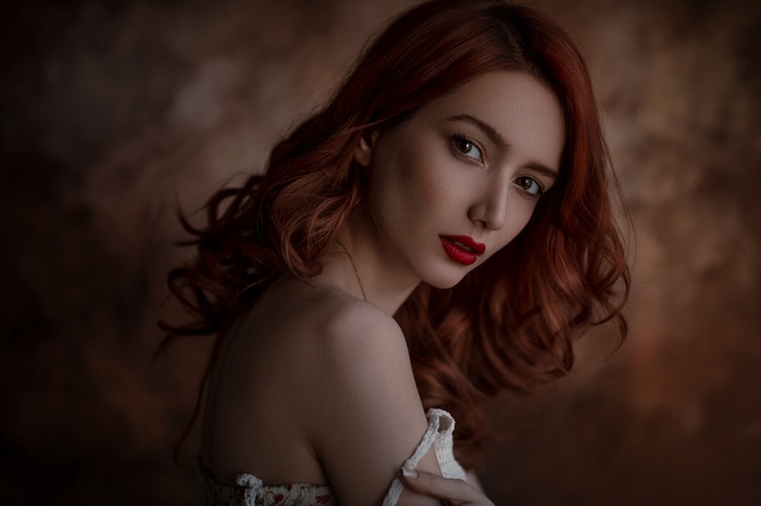Portrait of a redhead woman with red lipstick