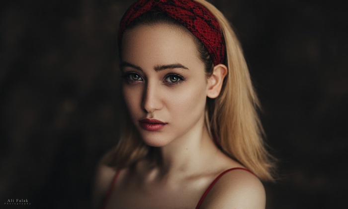 Portrait of a blonde woman with a red hairband