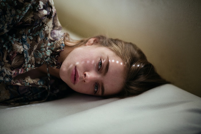 Woman with auburn hair lying down