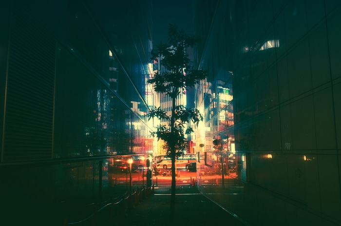 Nighttime cityscape with neon lights and a tree