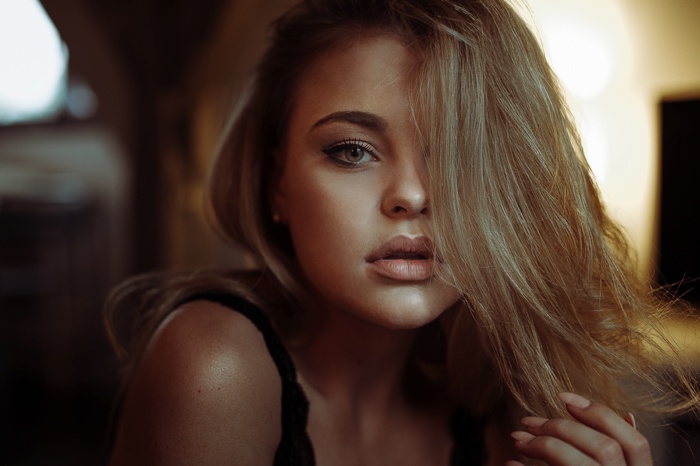 Woman with blonde hair covering her face