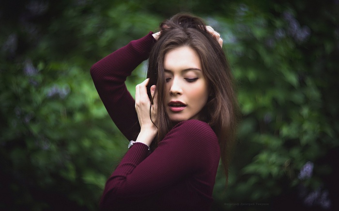 Portrait of a woman with hands in her hair
