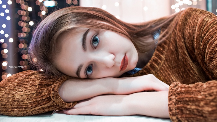 Portrait of a young woman with blue eyes and red lipstick