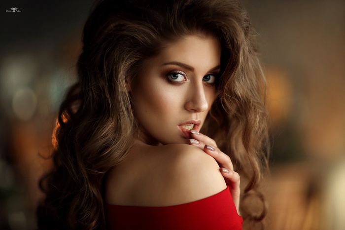 Woman with curly hair and red dress