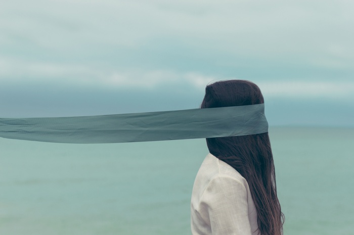 Woman with blindfold and long hair outdoors