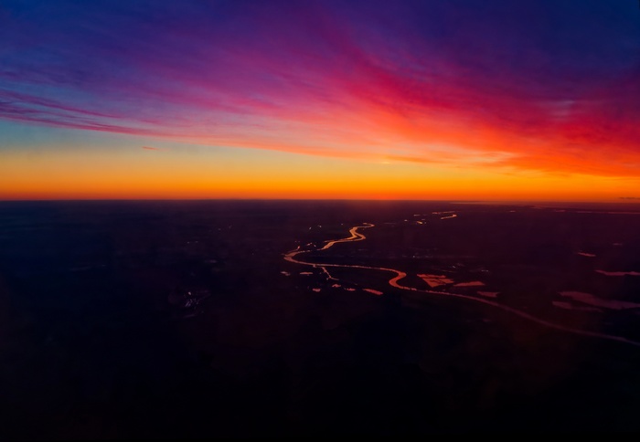 Colorful sunset over a winding river and landscape