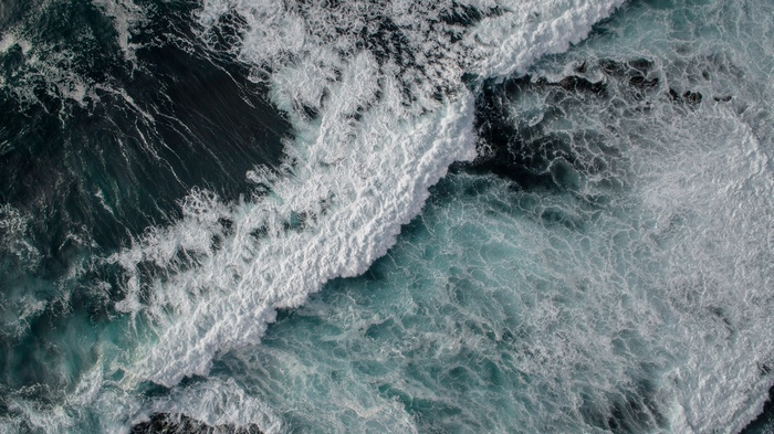 Aerial view of ocean waves crashing