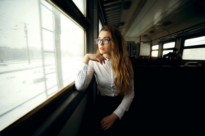 Woman with glasses on a train
