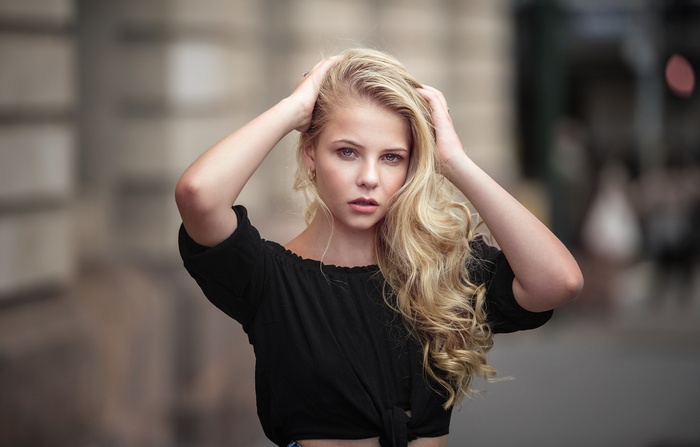 Woman with blonde hair and blue eyes outdoors