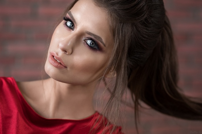 Woman with dramatic makeup and red dress