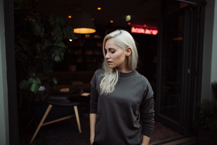Woman with blonde hair in a dark sweater
