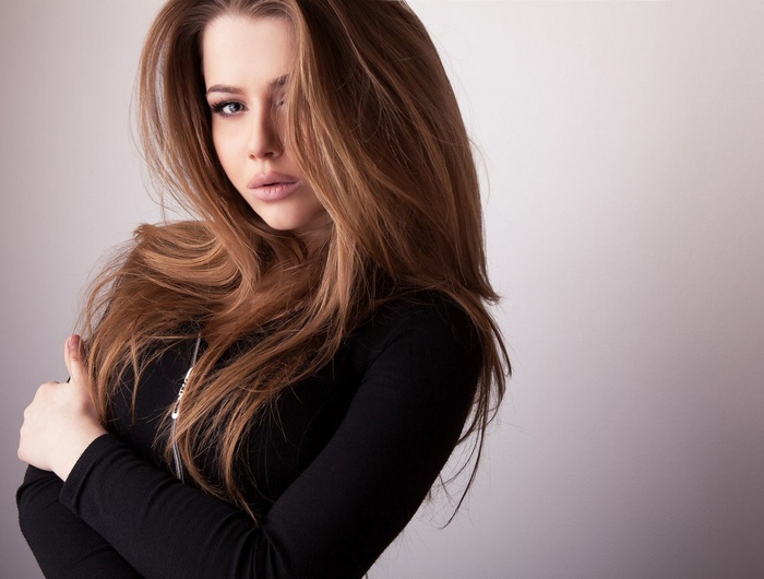 Alexandra Danilova with long brown hair and black clothing