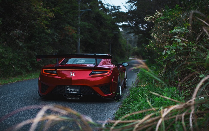 Red Honda NSX with LB Works kit on a road