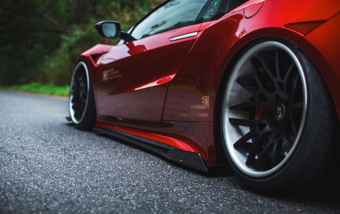 Red Honda NSX LB Performance on a road