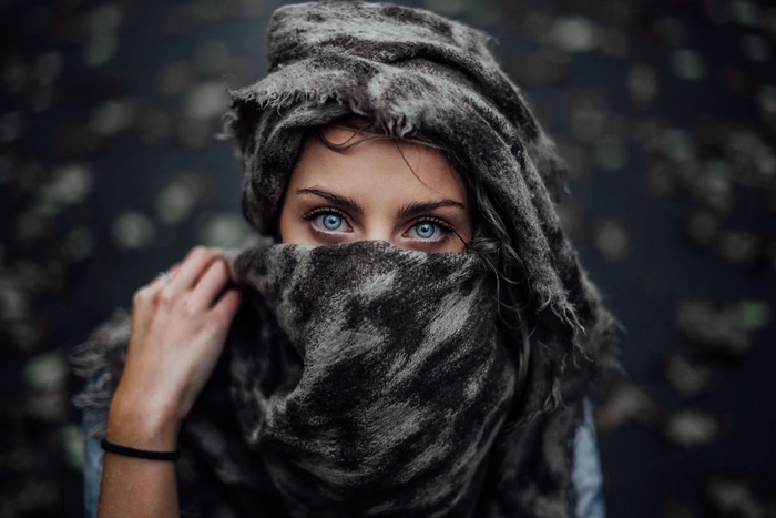 Woman with blue eyes wearing a scarf outdoors