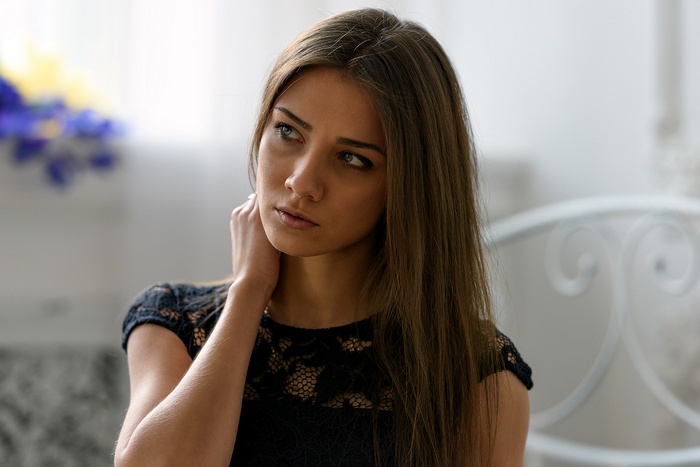 Woman with long brown hair in a black dress