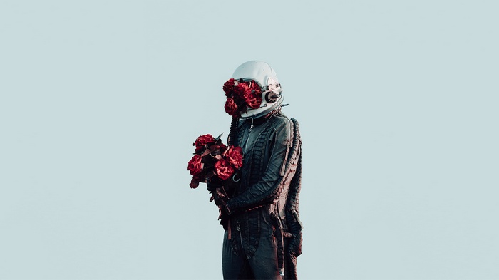 Astronaut with roses in helmet and bouquet