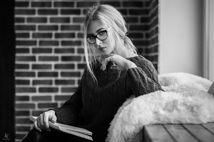 Woman with glasses reading a book