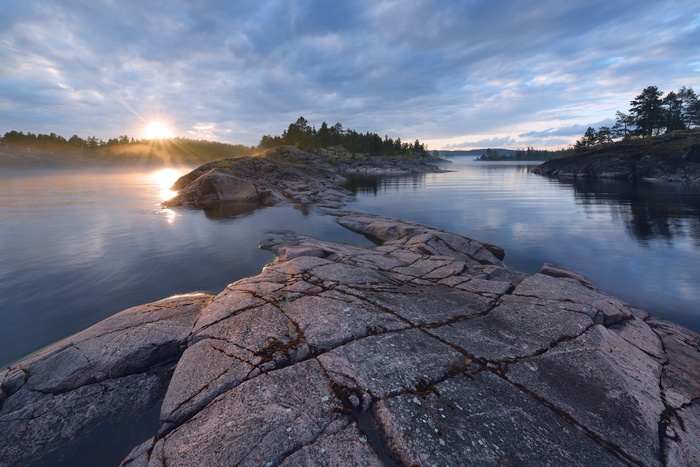 Sunrise over rocky islands on a lake