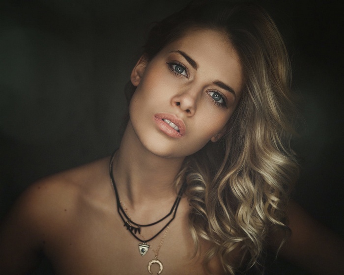 Woman with blonde hair and necklaces