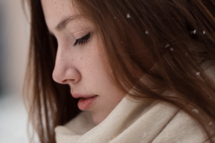 Woman with freckles and brown hair in scarf