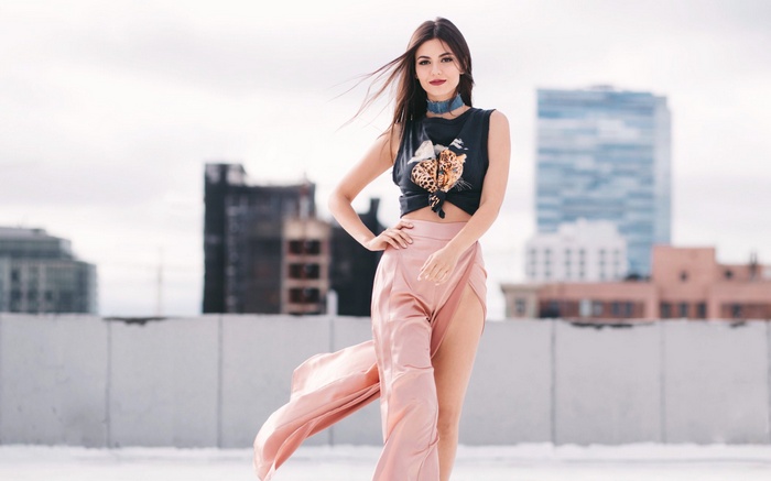 Victoria Justice posing on a rooftop