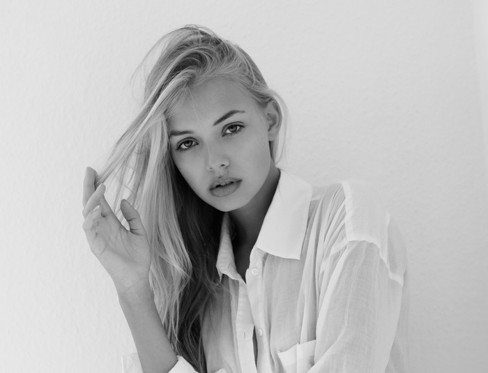 Monochrome portrait of a woman touching her hair