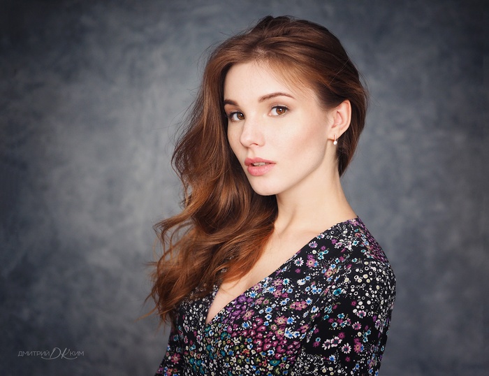 Woman with long brown hair in a floral dress