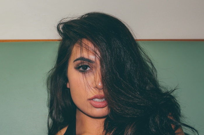Drisana Sharma portrait with hair in face