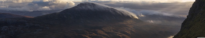Mountain landscape with clouds and sunbeams