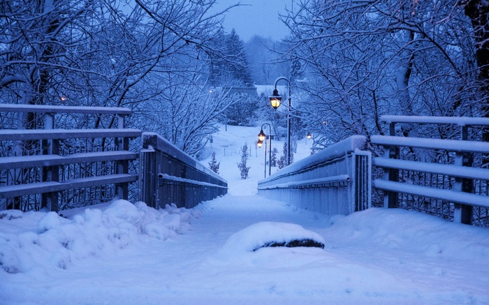 Snow covered bridge with lanterns in winter