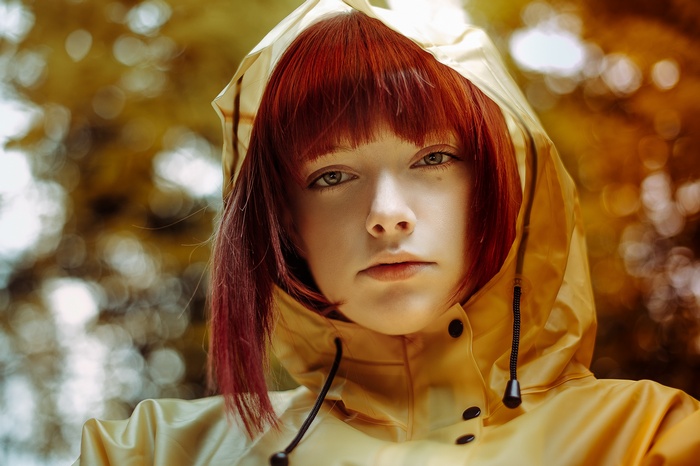 Redhead woman in yellow raincoat
