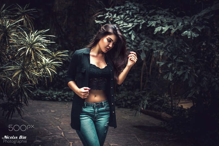 Woman in jeans and black top outdoors