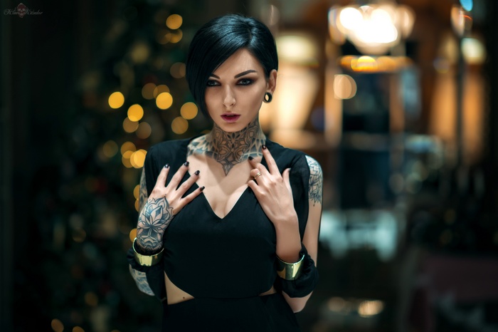 Woman with tattoos and short dark hair
