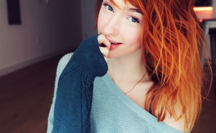 Redhead woman wearing a sweater indoors