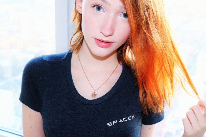 Redhead woman wearing SpaceX t-shirt with necklace