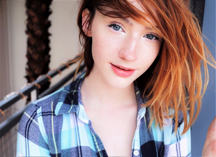 Redhead woman wearing a plaid shirt