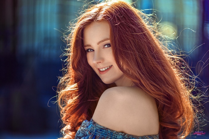Redhead woman with long hair outdoors