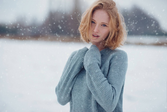 Woman in a blue sweater in the snow