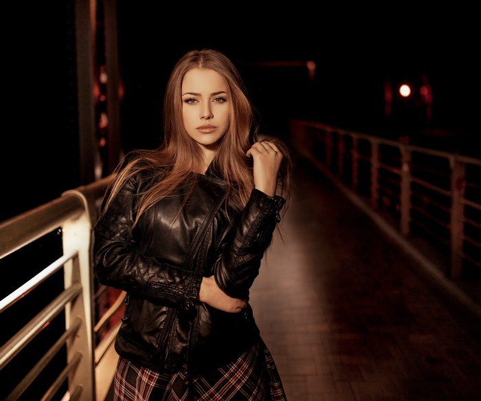 Alexandra Danilova wearing a leather jacket and skirt at night